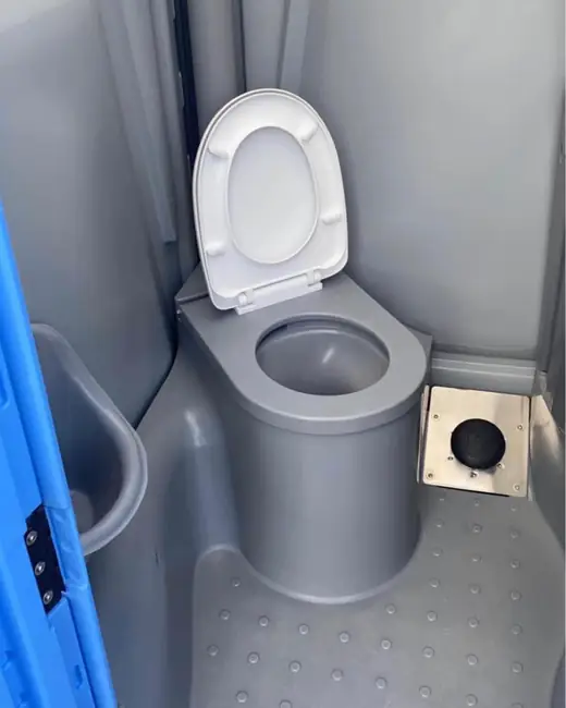 Flush-style toilet bowl inside a portable restroom