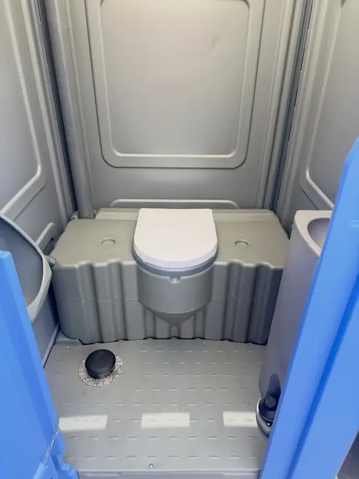 Clean toilet seat inside a standard porta potty