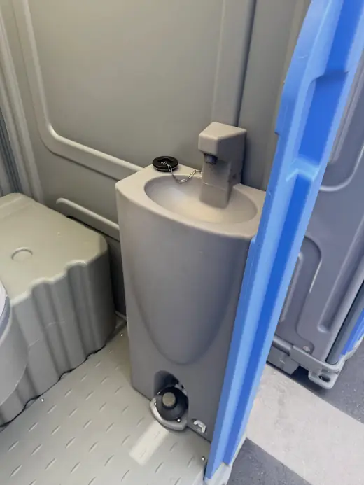 Foot-pump sink inside a standard porta potty
