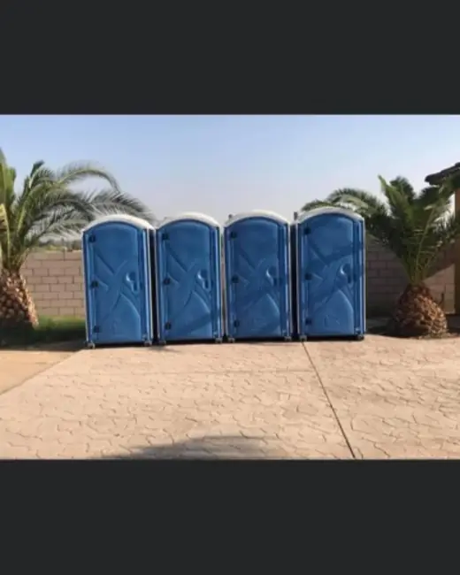 Four portable toilets in a row